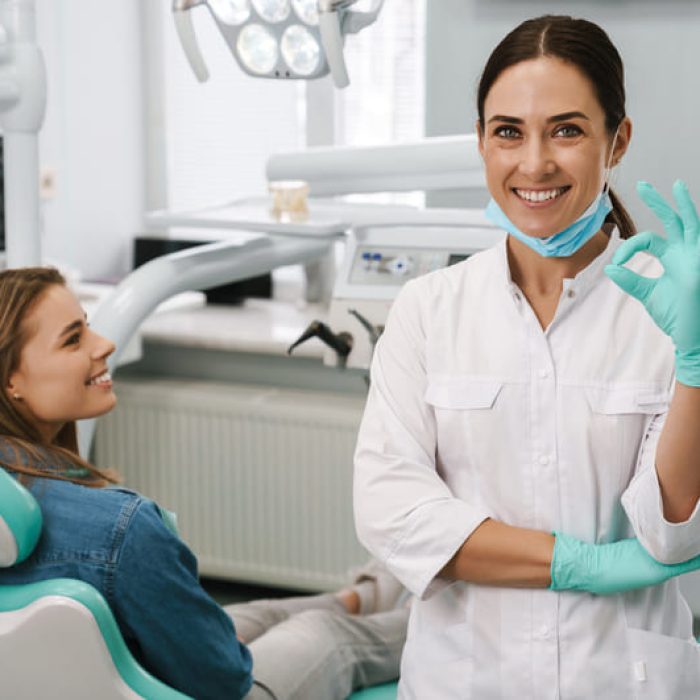 european-mid-dentist-woman-showing-ok-sign-while-w-2025-02-14-11-09-52-utc